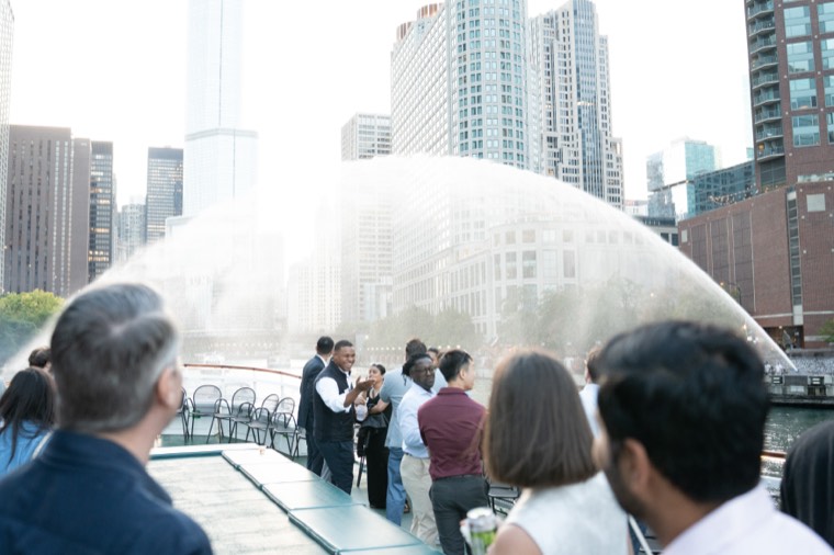 Guests on the top deck as the Centennial Fountain arcs over the Chicago River